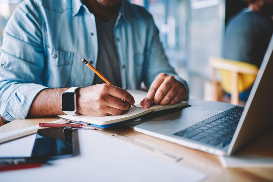 Person writing at a desk