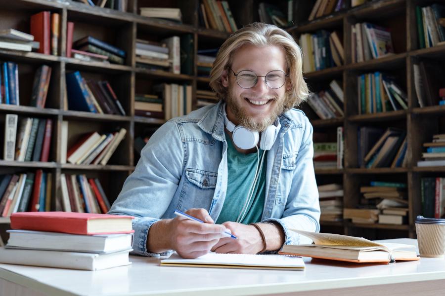 postgraduate creative writing uk Smiling student studying in the library
