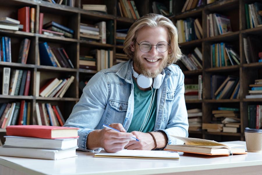 Smiling student studying in the library