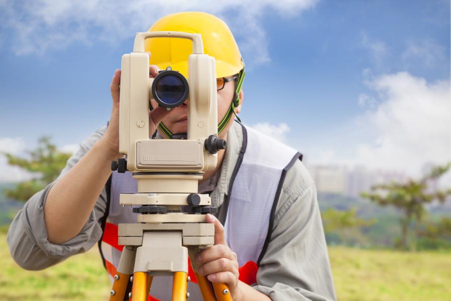 Surveyor taking land measurements