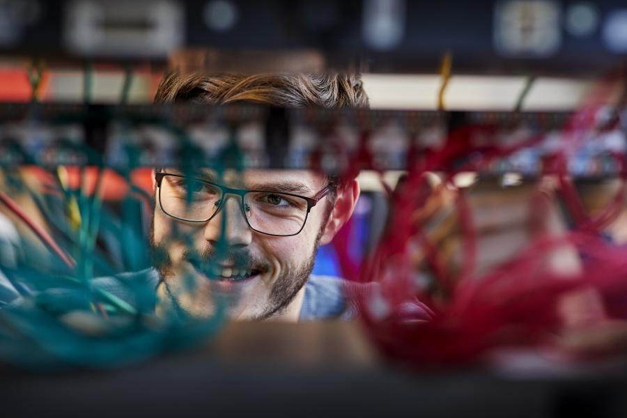 computer science student at work in a server room