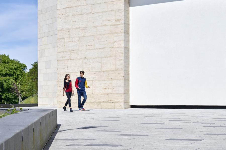 Two students walking outside the Pontio building