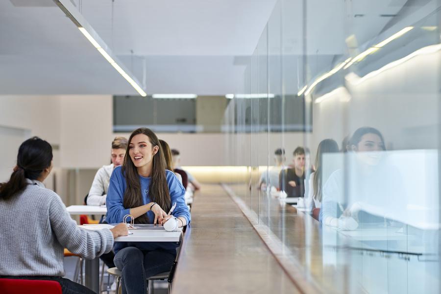 two students chatting in social learning space