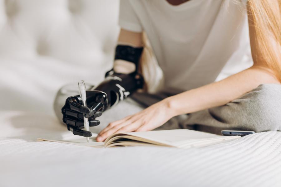 Learning to write with a prosthetic arm