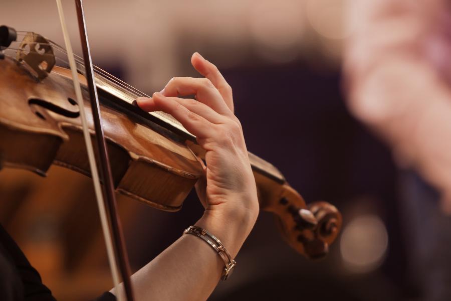 Close-up of a violin being played