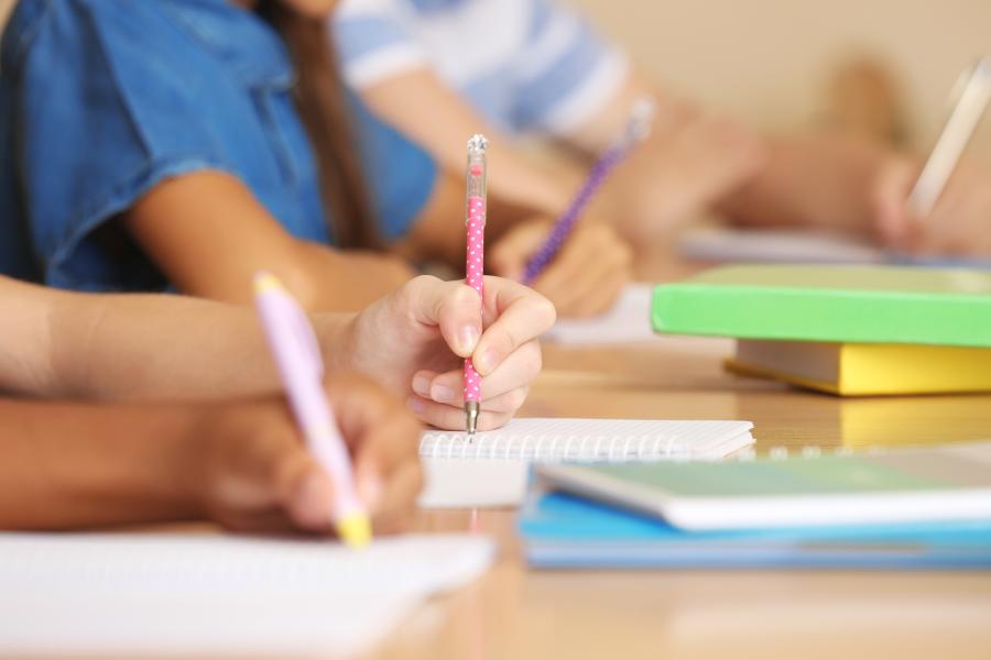 Children writing in classroom 