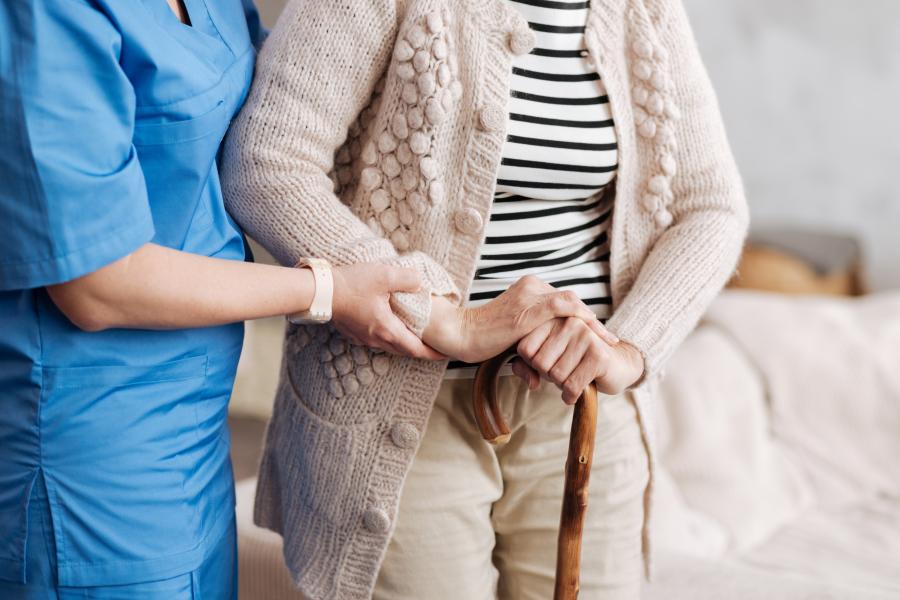 Nurse helping elderly lady