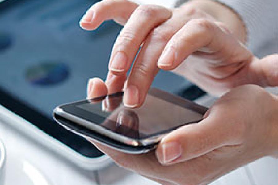 Hands typing on a smartphone