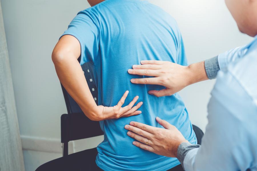 Therapist helping a client with back problems 