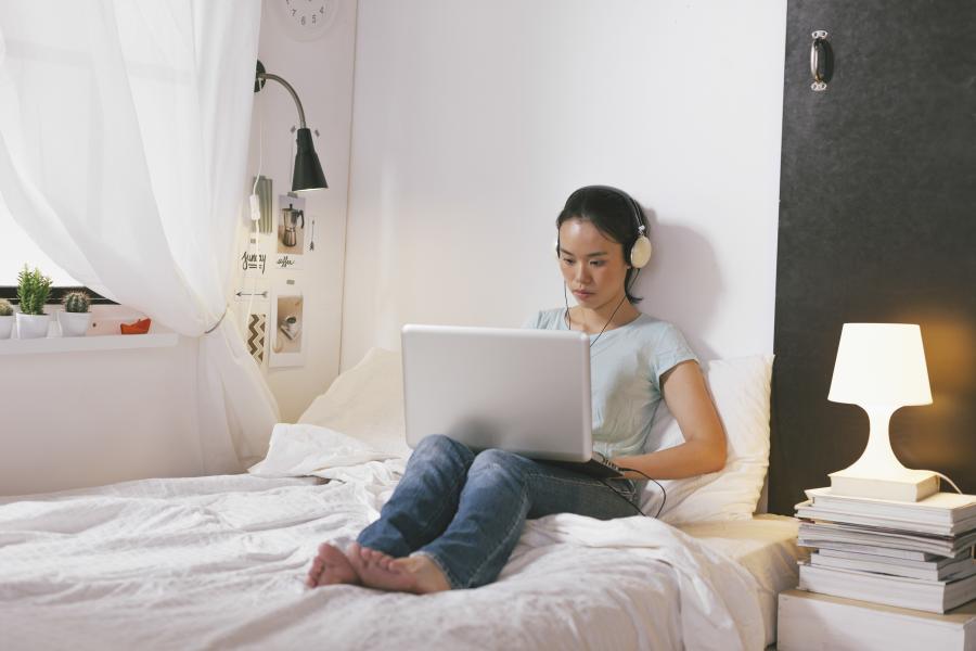 Student on laptop wearing headphones