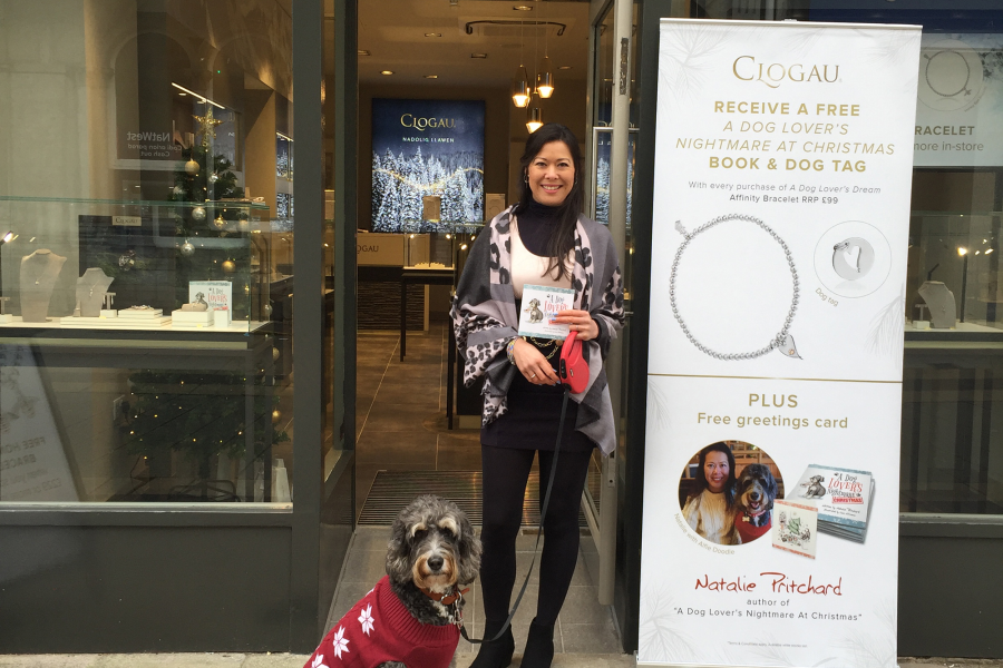 Woman with dog outside shop