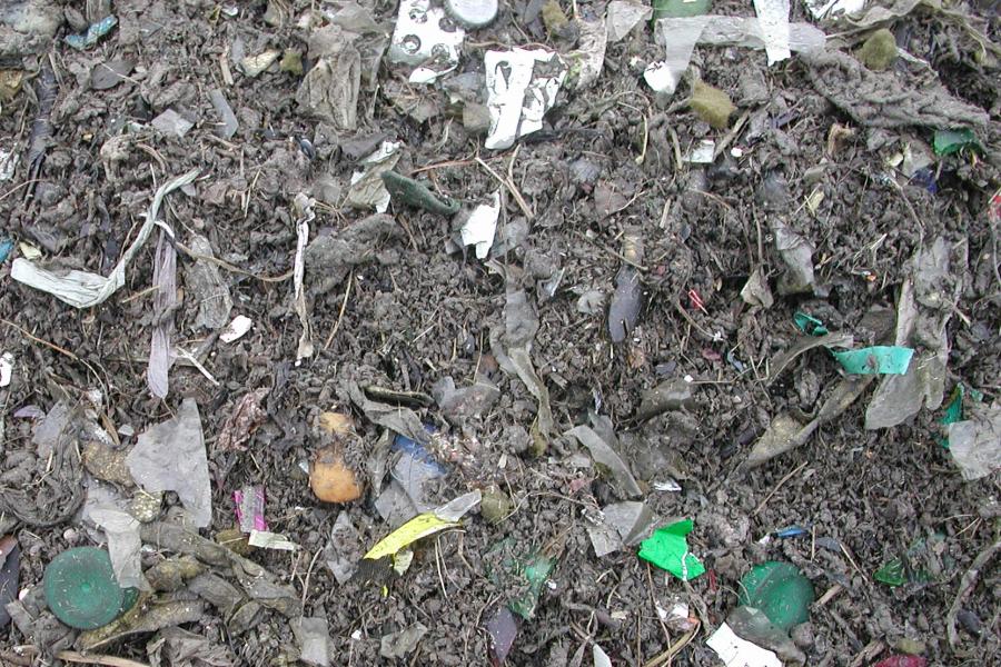 Pieces of plastic rubbish in soil