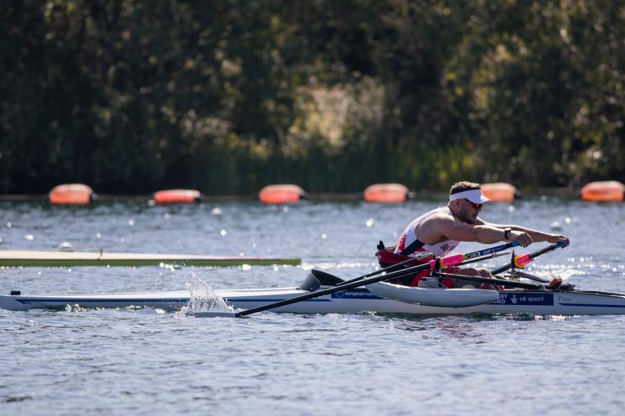 Man in single scull rowing boat