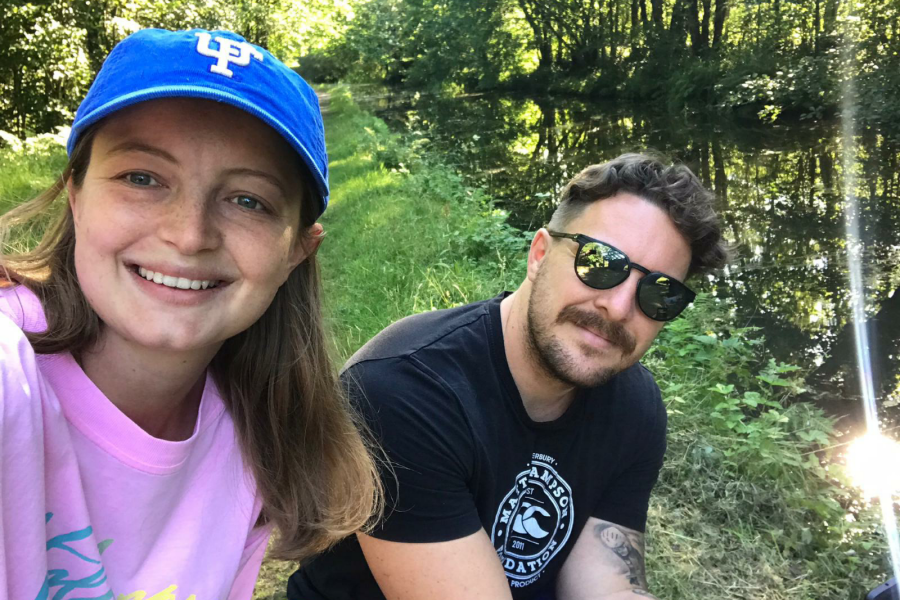 A young couple look smiling into a 'selfie'