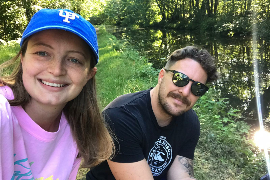 A  young couple look smiling into a 'selfie'