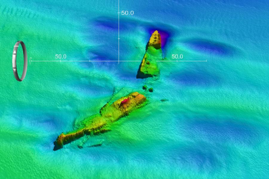 A broken ship lies on the sea bed- depicted by coloured sonar image