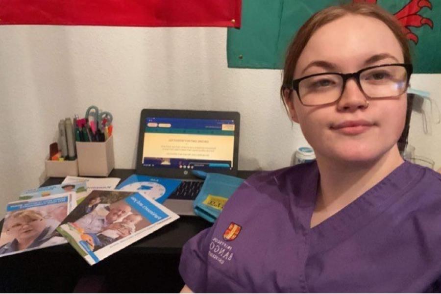 Bangor University nursing student Catrin Dafydd with her study desk in background
