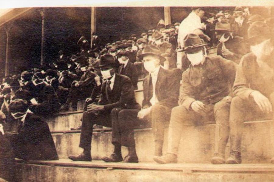 Historic image of crowd in football game 1918 wearing masks