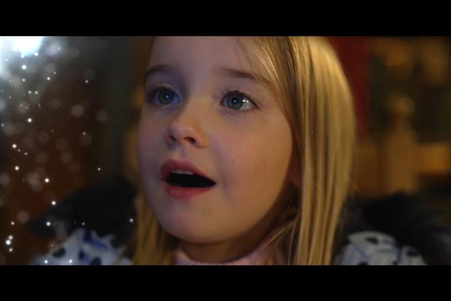 A little girl is delighted by a magical orb, in Bangor University's festive film