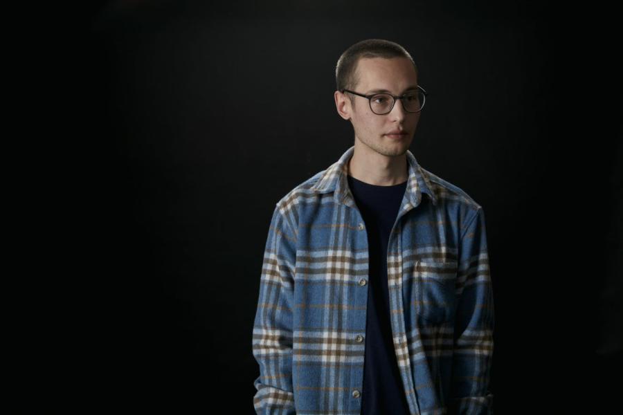 Dan Aberg stands in front of a black background