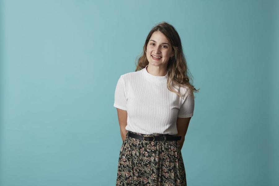 Dr Athanasia Papastergiou stands in front of green background
