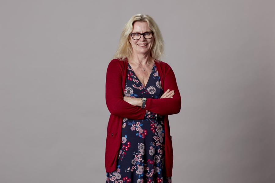 June Lovell of Betsi Cadwaladr Health Board stands in front of a grey background