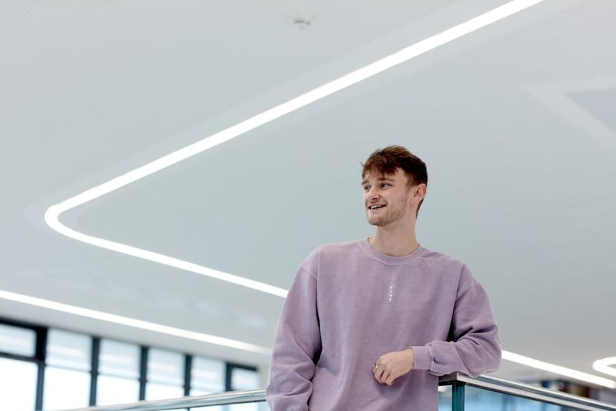 Kieran Hughes stands on a balcony in M-SParc