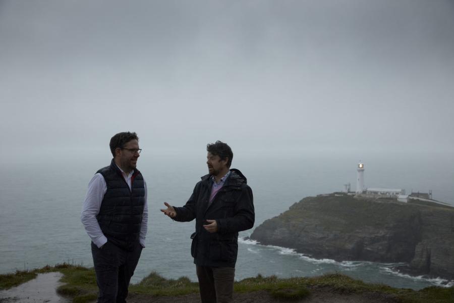 Two men stand near South Stack lighthouse