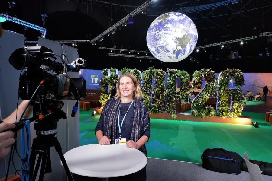 Prof Julia Jones stands in front of a camera at COP26