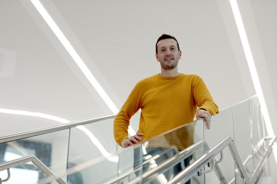 Pryderi Ap Rhisiart of M-SParc stands on stairs inside the building