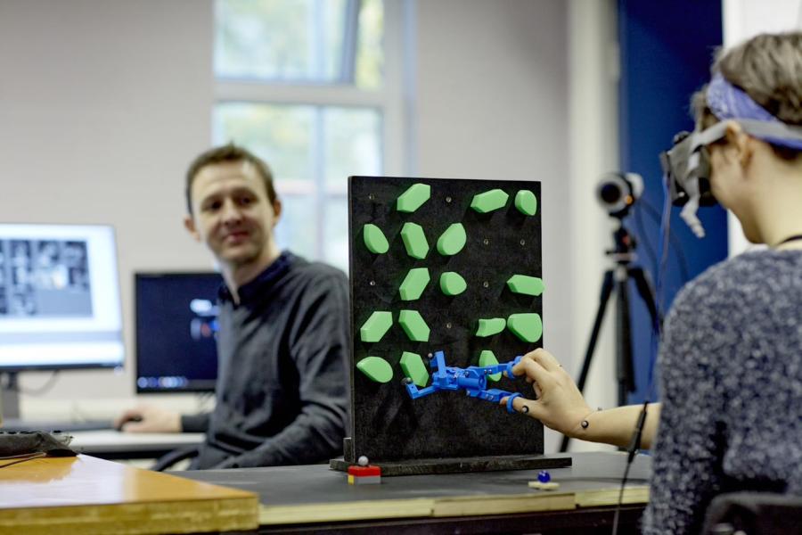 Dr Simon Watt and a female researcher undertaking prosthesis research