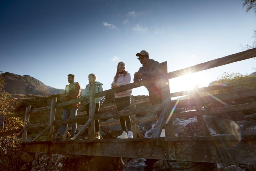 Students in Snowdonia standing on a footbridge