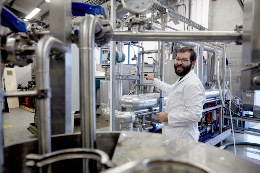 A man in a lab coat working in industry