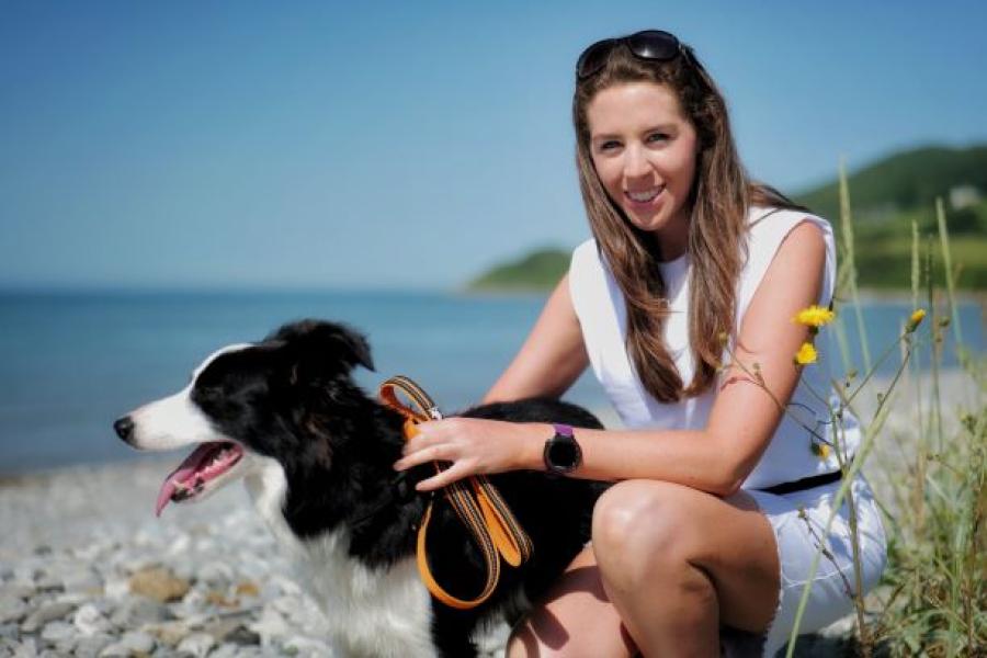 Dr Jennifer Cooney on the beach with a dog