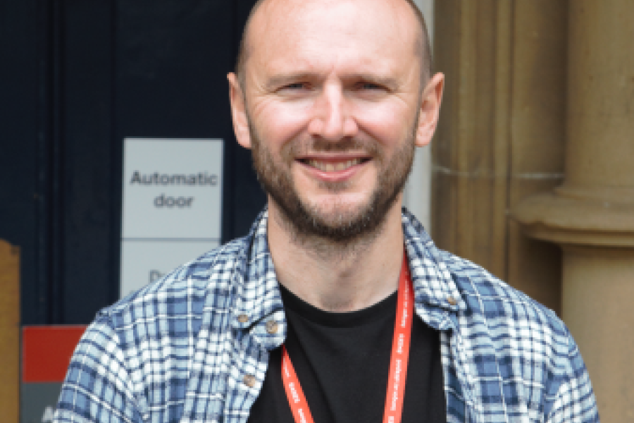 Kevin Williams standing in front of Bangor University building