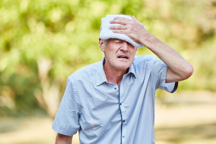 Man standing outside with a flannel on his head