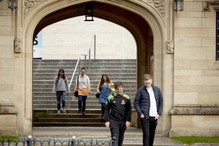 Students walking from Pontio through Memorial Arch