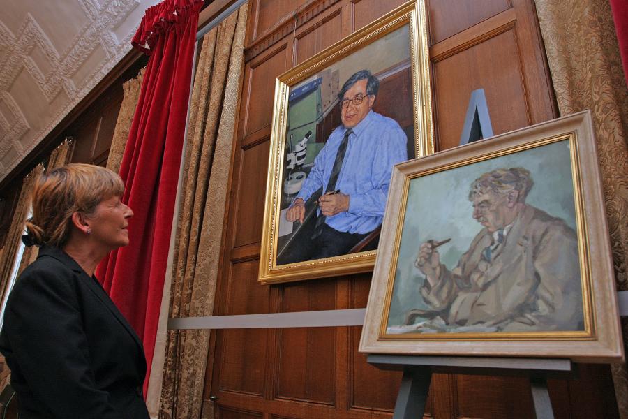 Dr Jenny Joy studies the painting of her father, Sir Robert Edwards (also pictured on the right is the portrait of Francis William Rogers Brambell, who taught Sir Robert Edwards).