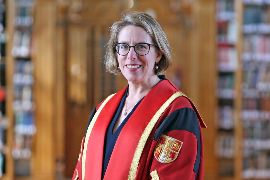 Dr Rebecca Heaton in Bangor University gown in the Shankland Reading Room
