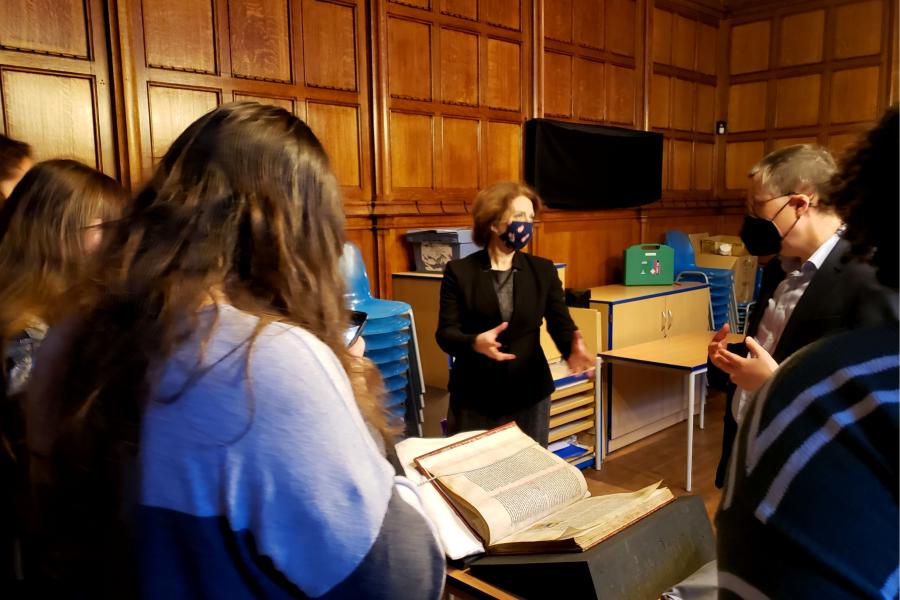 Prof Raluca Radulescu and students in the John Rylands Library with manuscripts