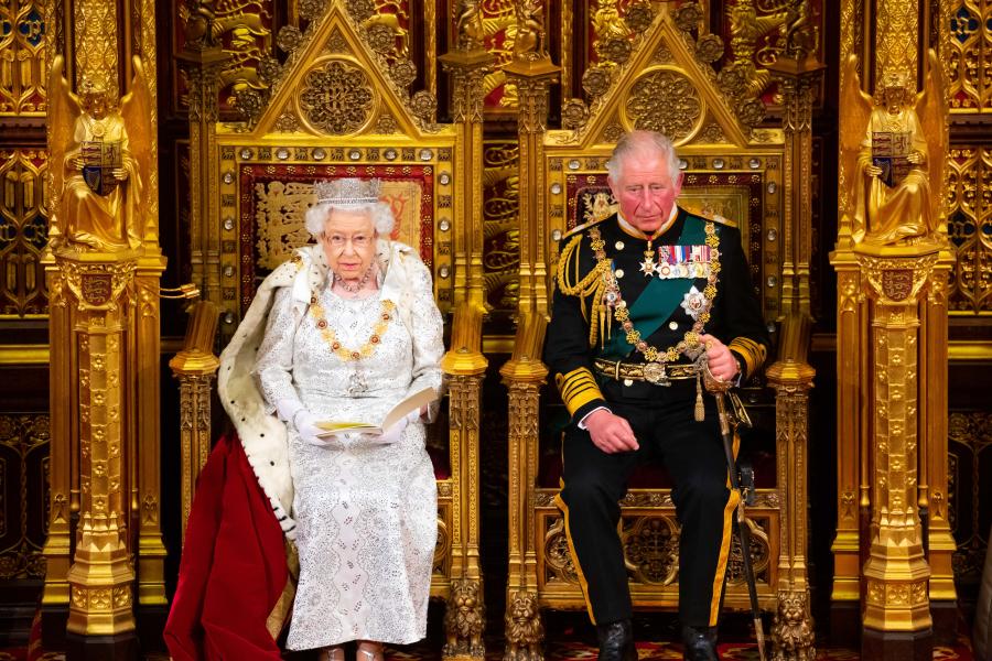 the late Queen and new King Charles iii sit on thrones wearing full regalia at the state ooening of Parliament