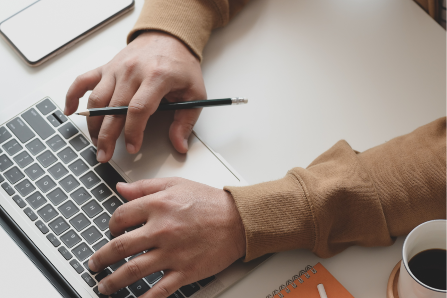 Close up of someone using an Apple Mac laptop