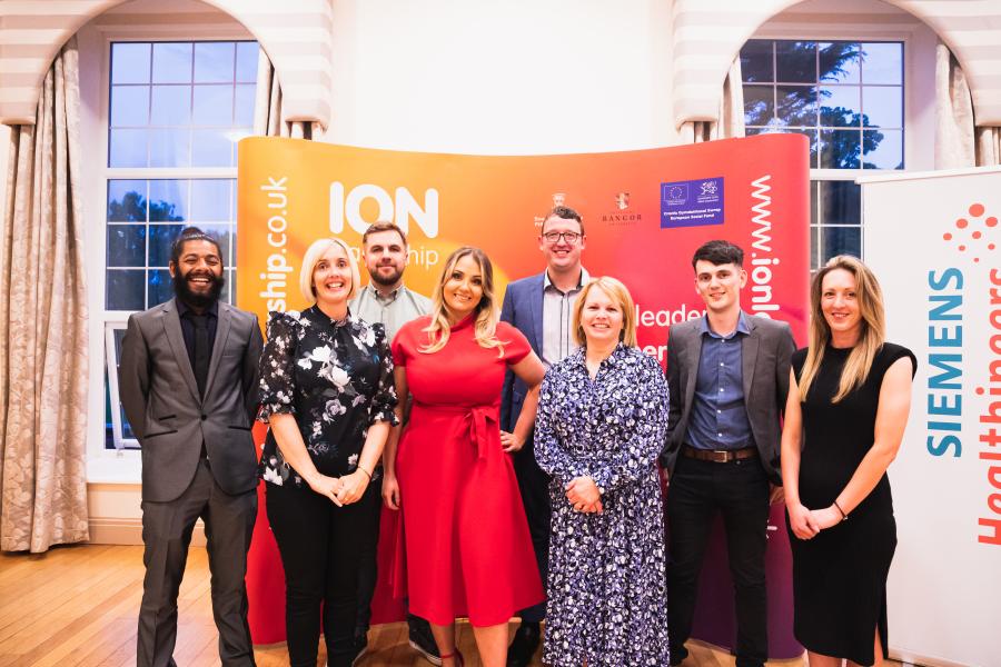 Group of participants of the Leadership Programme in front of an ION Marketing banner