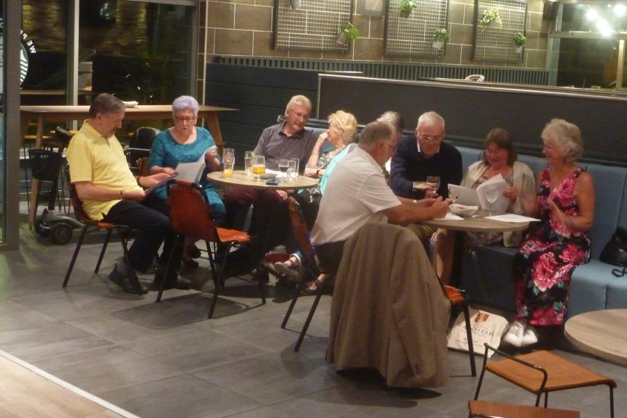 Bar Uno 60's to 70's Reunion group sitting around tables in the evening