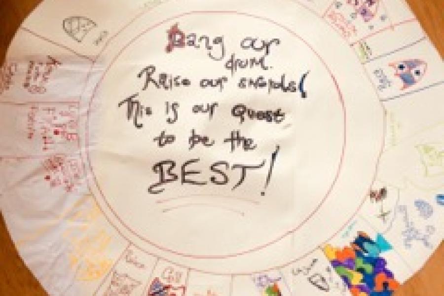 Paper plate with child's writing on it, featuring medieval shields 