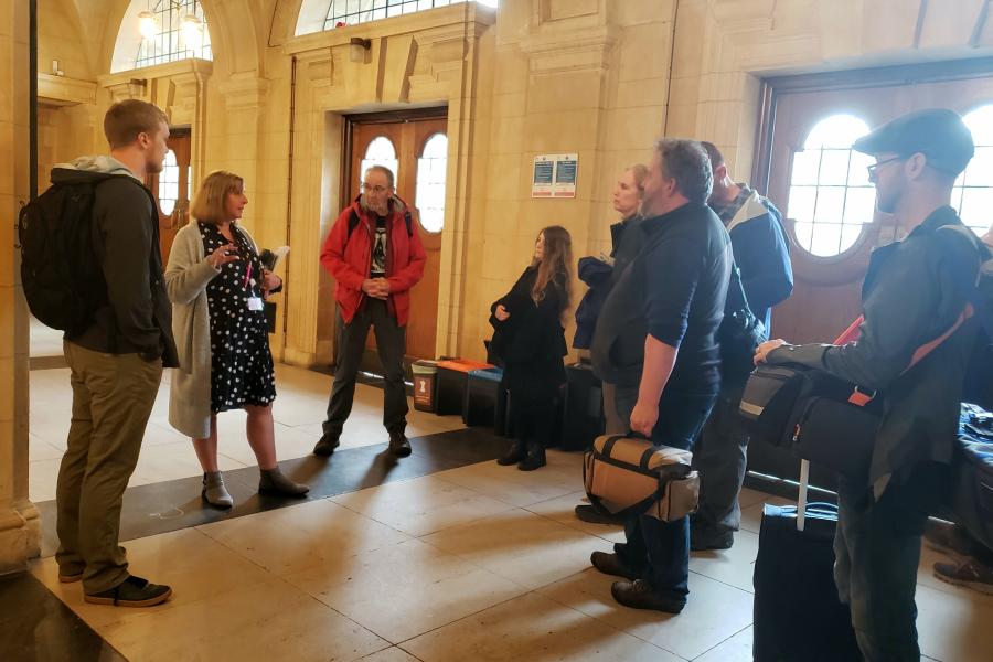 Shan Robinson speaking to crowd of people giving tour in Bangor University