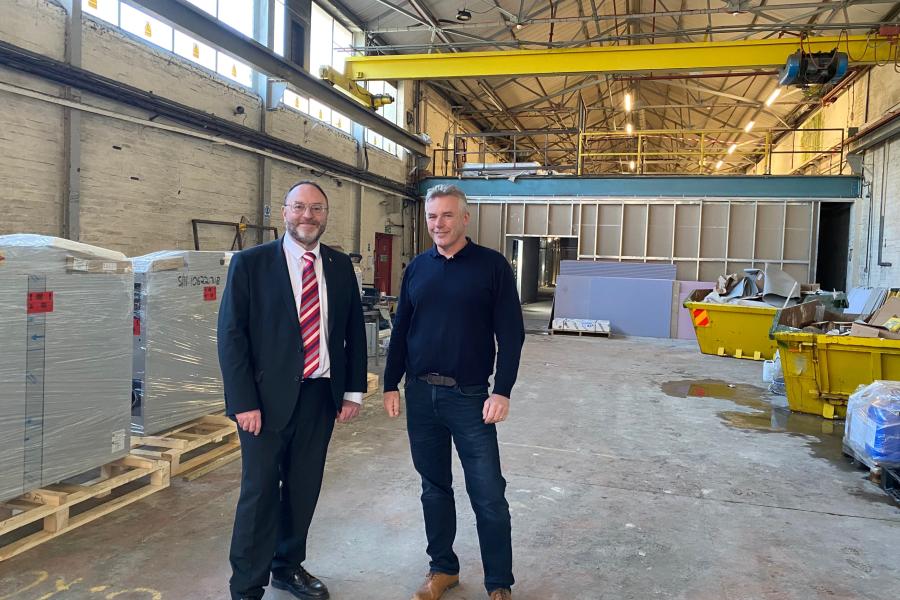 Two men standing on construction site