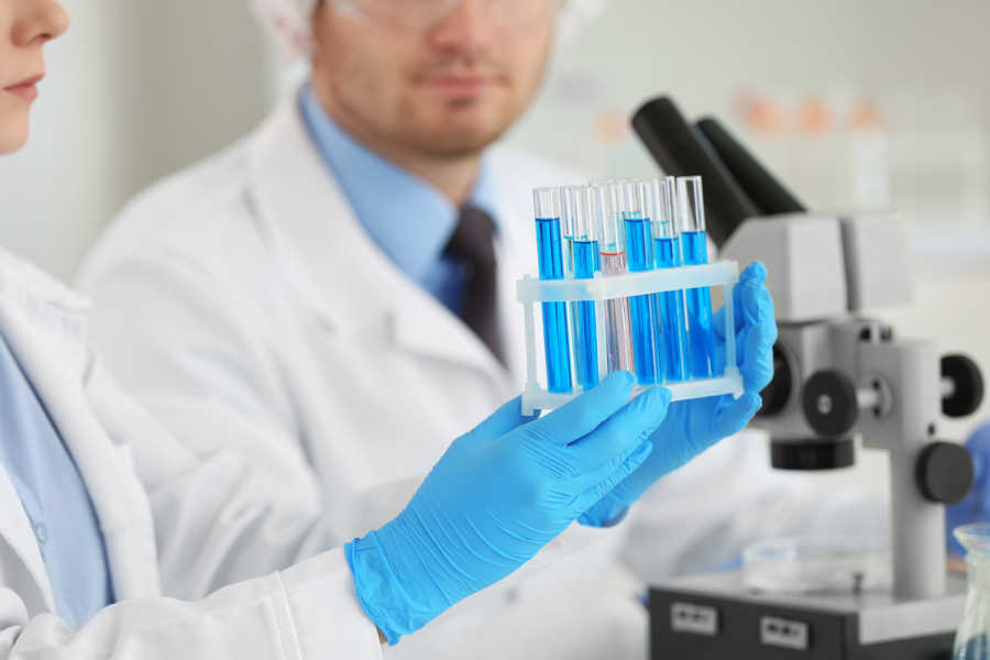 Female holding test tubes in a lab