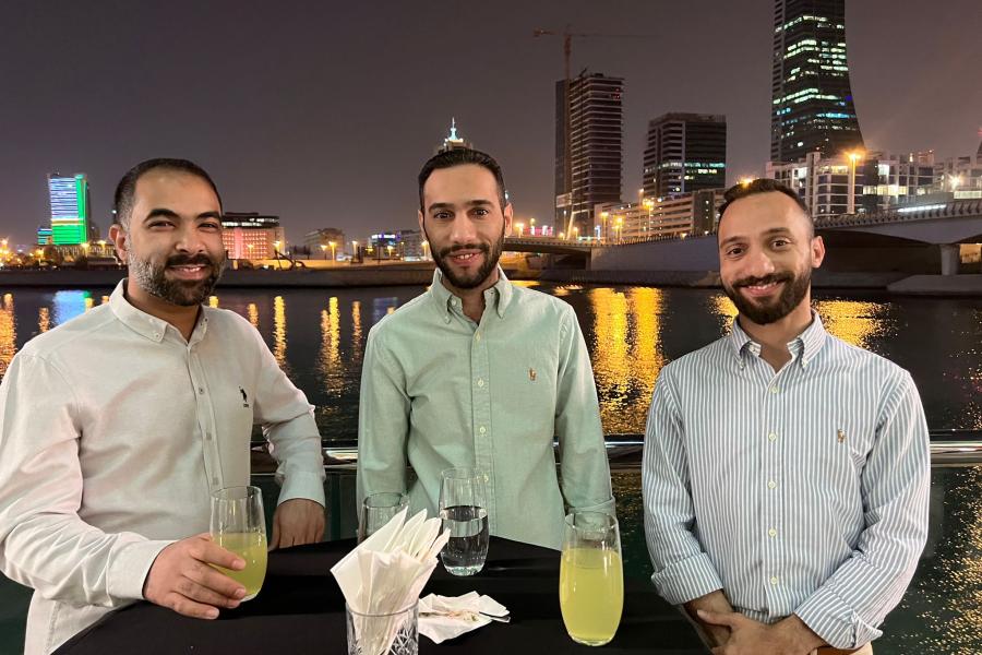 Three guests smiling at the camera during Bahrain reunion 2022