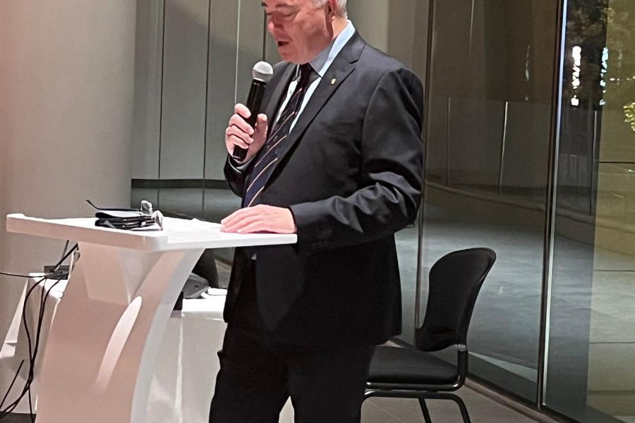 Prof. Andrew Edwards at podium speaking during Bahrain reunion 2022